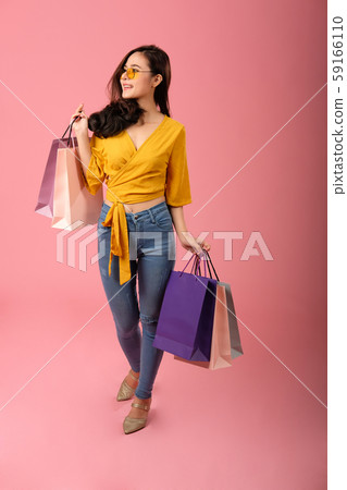 woman holding shopping bags. consumerism lifestyle studio shot 59166110