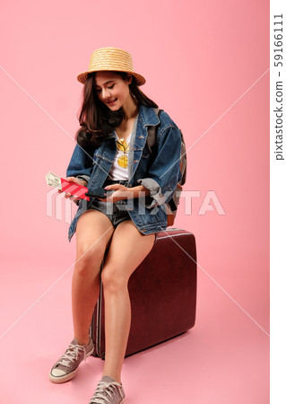 woman backpacker traveler with smartphone passport money. journey trip travel. studio shot 59166111