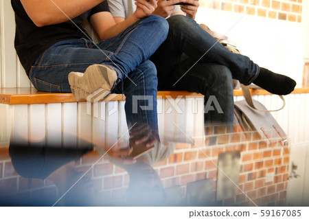 man student using smart mobile phone with friend, teenager lifestyle 59167085