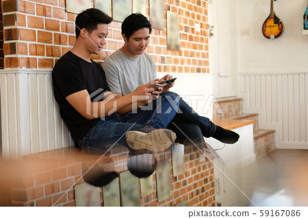 man student using smart mobile phone with friend, teenager lifestyle 59167086