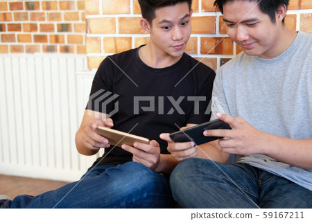 man student using smart mobile phone with friend, teenager lifestyle 59167211