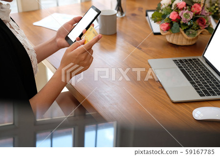woman holding mobile smart phone & credit card for online shopping woman holding mobile smart phone & credit card for online shopping 59167785