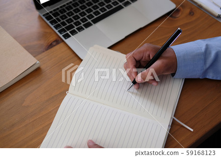 man writing note on notebook. businessman working organizing plan at workplace man writing note on notebook. businessman working organizing plan at workplace 59168123
