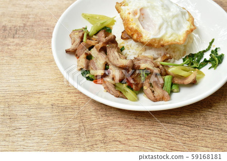 spicy stir fried slice grilled pork with chili and basil leaf topping egg on dish spicy stir fried slice grilled pork with chili and basil leaf topping egg on dish 59168181