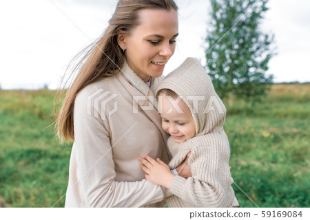 Mom woman with little boy son 4-5 years old, hugging park. Happy people play laughing having fun 59169084