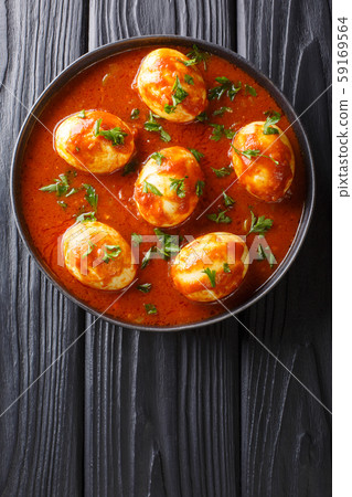 Curry egg recipe in spicy sauce close-up in a Curry egg recipe in spicy sauce close-up in a 59169564