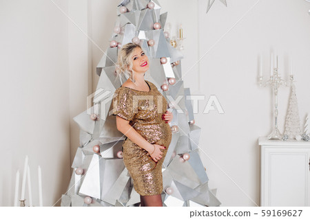 Beautiful pregnant woman in sparkling party dress Beautiful pregnant woman in sparkling party dress 59169627