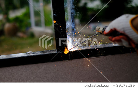 Welder Technician are welding steel with sparks flying Welder Technician are welding steel with sparks flying 59172189