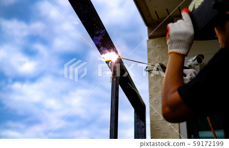 Welder Technician are welding steel with sparks flying 59172199