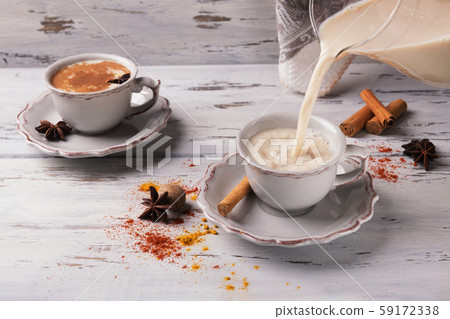 traditional indian masala chai tea pour on a beautiful cup ona shabby wooden texture background, top view. I 59172338