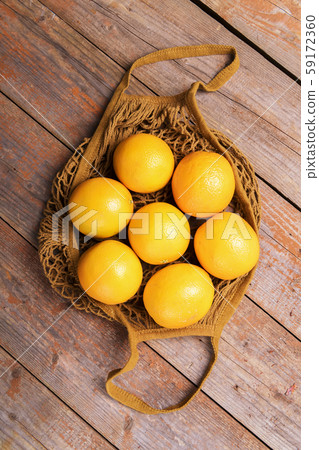 Top view of fresh organic oranges in string bag Top view of fresh organic oranges in string bag 59172360