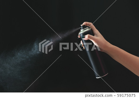 Hand using a spray, isolated on black background. Hand using a spray, isolated on black background. 59175075