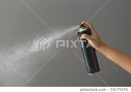 Hand using a spray, isolated on grey background. Hand using a spray, isolated on grey background. 59175076
