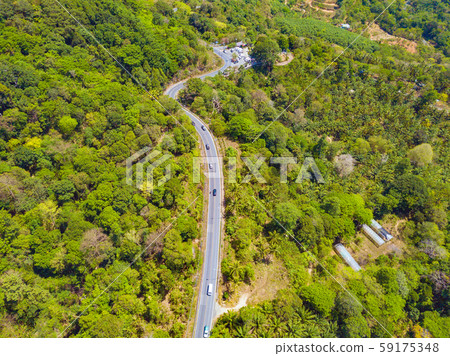 Aerial view of cars driving on curved, zigzag road Aerial view of cars driving on curved, zigzag road 59175348