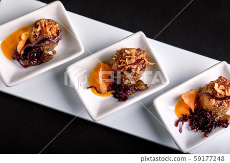 Canapes beef rolls with pumpkin sauce, on white plates 59177248