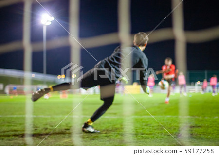Goalkeeper catch the ball when defensive on goal during a football match 59177258