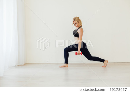 Beautiful blonde woman sports with fitness dumbbells Beautiful blonde woman sports with fitness dumbbells 59178457