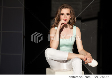Portrait of a beautiful fashionable woman in light clothes Portrait of a beautiful fashionable woman in light clothes 59178656