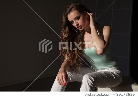 Portrait of a beautiful fashionable woman in light clothes Portrait of a beautiful fashionable woman in light clothes 59178659
