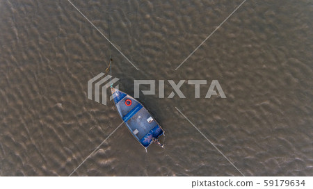 Aerial. An old fishing boat from above, on the Tejo River, in the Samouca Marina. Lisbon. Aerial. An old fishing boat from above, on the Tejo River, in the Samouca Marina. Lisbon. 59179634