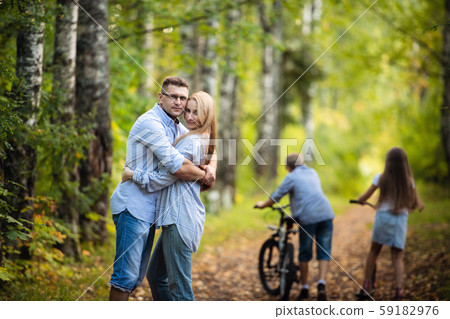 Family Group Standing Outdoors At Green Park In Autumn Landscape 59182976