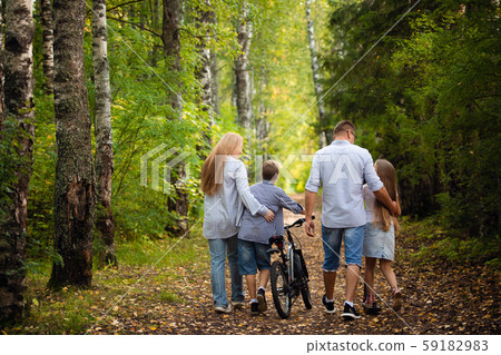Portrait of happy family of four in a green summer park 59182983