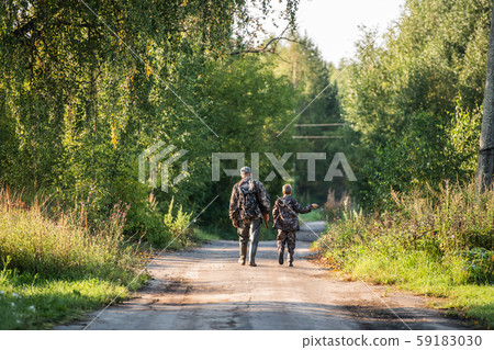 A ranger teaching his son about spotting the game in the wilderness 59183030