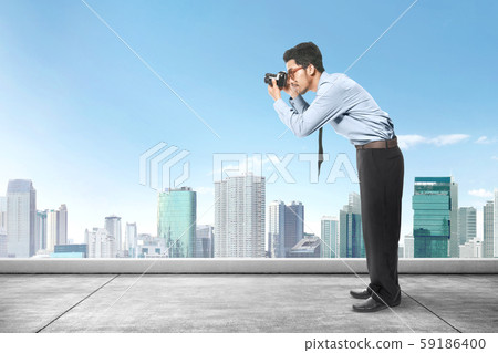 Asian businessman take a picture with his camera 59186400