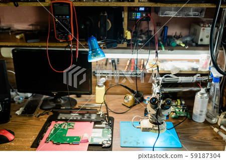 Workplace of repairman with details of demounted gadgets other supplies Workplace of repairman with details of demounted gadgets other supplies 59187304