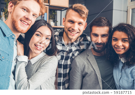 Startupers working together at office standing hugging taking selfie photos cheerful close-up 59187715