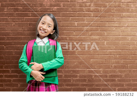 Asian cute girl with a backpack holding the book 59188232