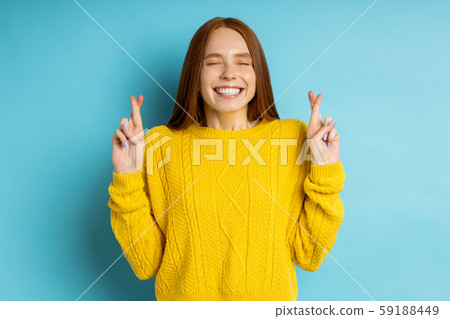 Studio shot of redhead caucasian young woman isolated blue background Studio shot of redhead caucasian young woman isolated blue background 59188449