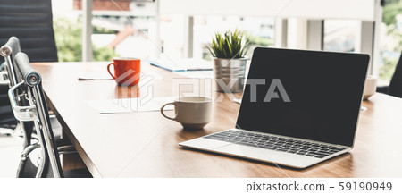 Laptop computer on the table in meeting room. 59190949