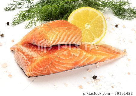 Slices of salmon with lemon and dill, close-up with salt and pepper, cooking fish, on a white 59191428
