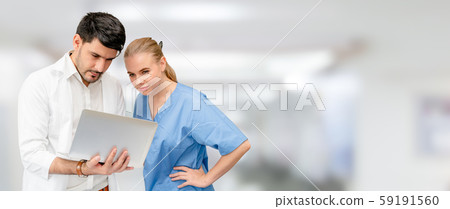 Doctors at hospital working with another doctor. Doctors at hospital working with another doctor. 59191560