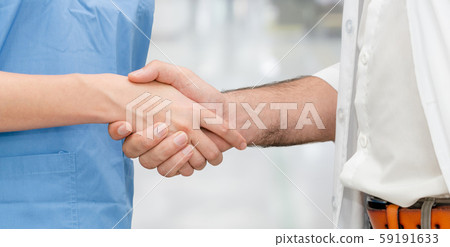 Doctor in hospital handshake with another doctor. Doctor in hospital handshake with another doctor. 59191633