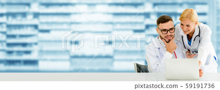 Doctors working with laptop computer in hospital. 59191736