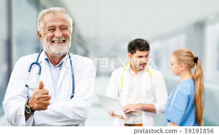 Doctor working in hospital with other doctors. 59191856