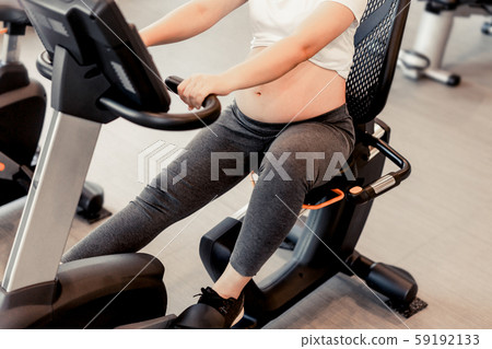 Active pregnant woman exercise in fitness center. 59192133