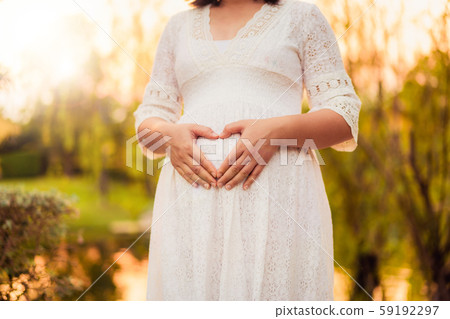 Pregnant woman feeling happy at garden home. Pregnant woman feeling happy at garden home. 59192297