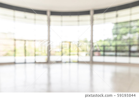 Blur background interior view looking out toward to empty office lobby and entrance doors and glass curtain wall Blur background interior view looking out toward to empty office lobby and entrance doors and glass curtain wall 59193844
