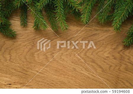 Flat lay christmas background with spruce twigs on oak wood surface 59194608