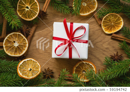 Flat lay christmas composition with white gift box, spruce branches and natural decorations 59194742