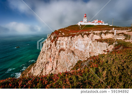 Cabo da Roca Lighthouse at sunlight and beautiful cloudscape. Most westerly point of the Europe Cabo da Roca Lighthouse at sunlight and beautiful cloudscape. Most westerly point of the Europe 59194892