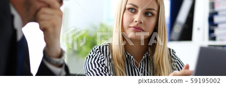 Beautiful blonde secretary sitting at workplace talking with boss Beautiful blonde secretary sitting at workplace talking with boss 59195002