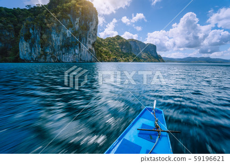 Island hopping Tour boat on speed passing exotic karst limestone islands on travel tour trip Island hopping Tour boat on speed passing exotic karst limestone islands on travel tour trip 59196621