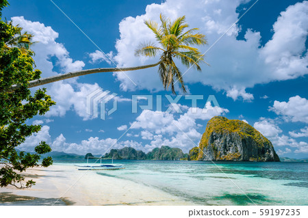 El Nido, Palawan, Philippines. Tropical scenery of exotic beach with palm tree, boat on the sandy 59197235