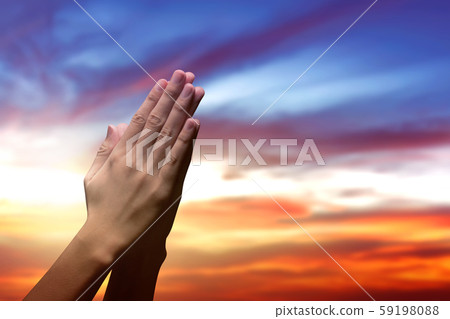 Human hands raised while praying to god 59198088