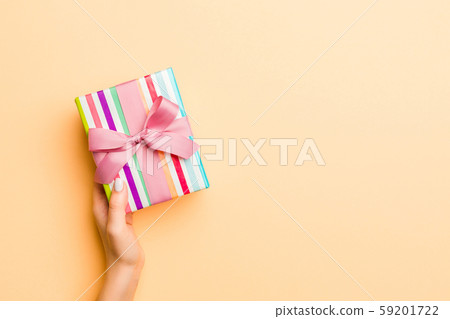 Flat lay of woman hands holding gift wrapped and 59201722