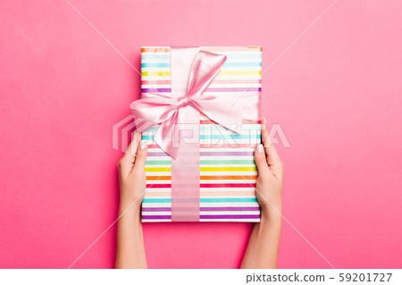 Girl Hands holding craft paper gift box with as a 59201727